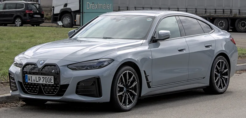 A gray BMW i4, seen from the front-left three-quarter angle, parked on a street in Boblingen, Germany, in April 2022.
