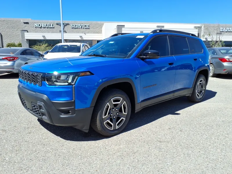 A blue 2026 Jeep Cherokee Limited (trim per the Commons file title) parked in a lot, seen from the front left three-quarter angle, its driver's side facing the camera.