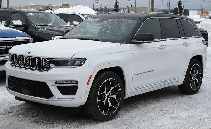 A white 2022 Jeep Grand Cherokee Summit Reserve 4x4, seen from the front left.
